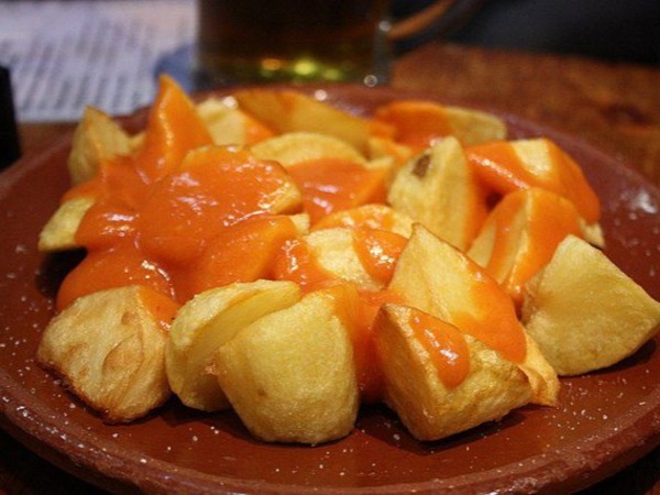 Fried potatoes in a spicy tomato sauce