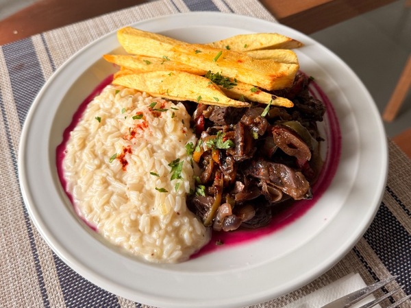 Spicy veal with rice and wedge potatoes