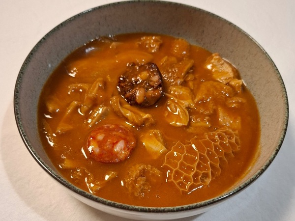 Stewed tripe in sauce with chorizo and black pudding